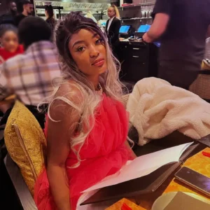 Black girl with silver hair with a menu at restaurant